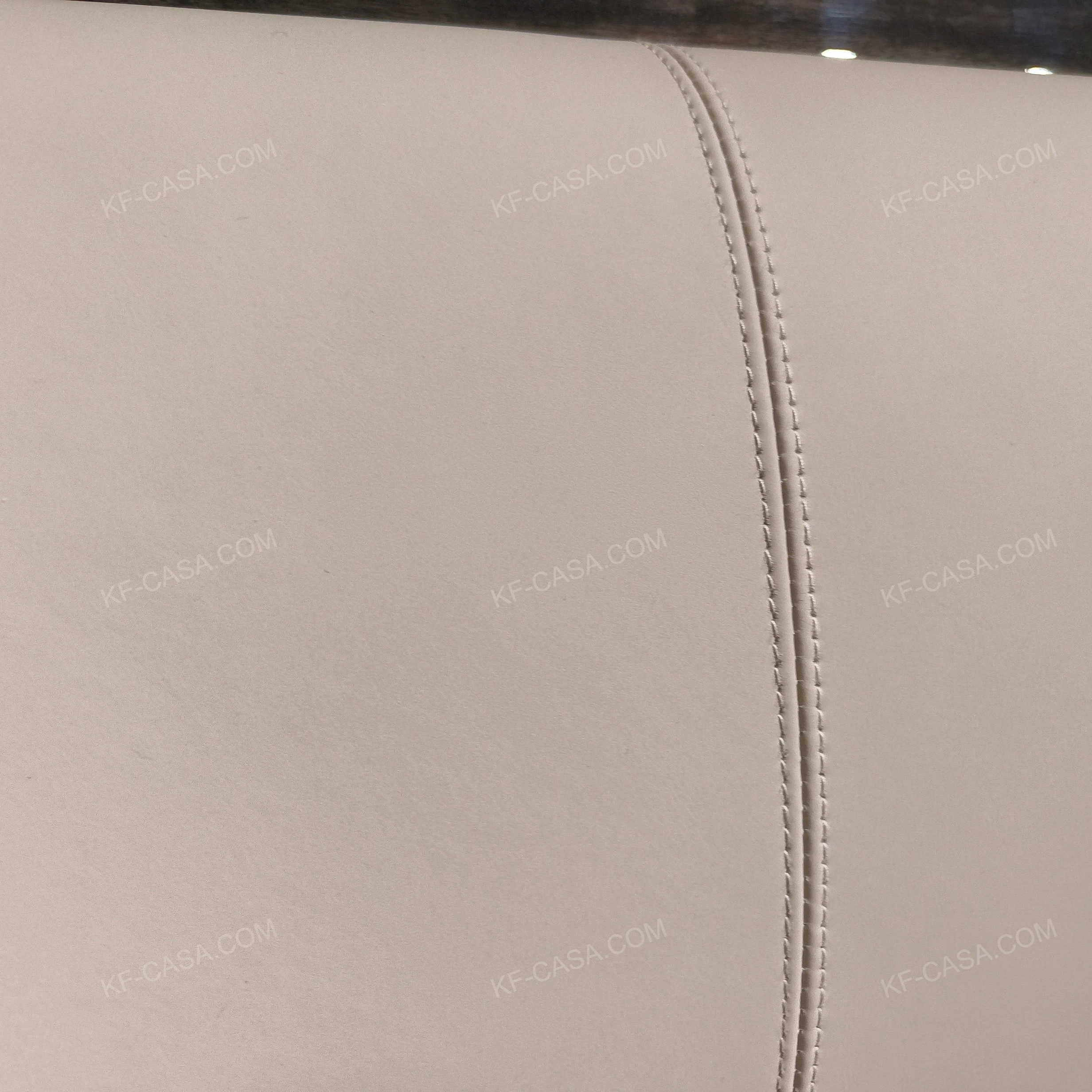 Soft Upholstered Bed with Embossed Brand Mark, Rich-Patterned Natural Wood Veneer Trim & Polished Gold Stainless Steel Accents